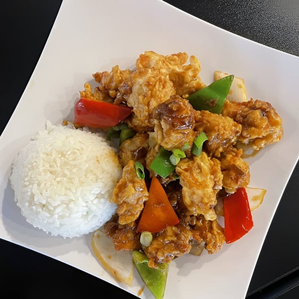 Fusion Tea Lounge's sweet and sour chicken with bell peppers, onions, and a side of white rice.